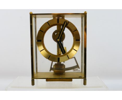 A vintage Kieninger & Obergfell Kundo skeleton mantel clock, brass cased with four glass panels and raised on four supports, 