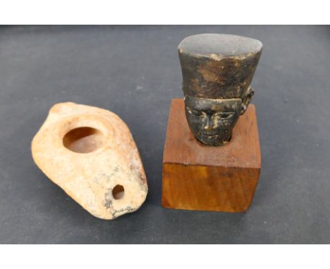Egypt - A light terracotta oil lamp and a carved stone bust mounted to wooden plinth, 9 cm (h). [W]