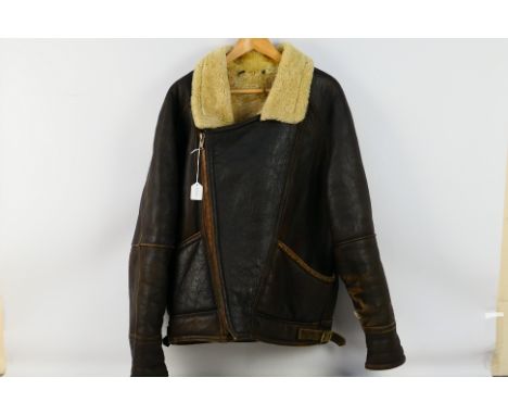 Military - A Sheep-Skin lined flying jacket (Medium) with zip. Item appears fair-good overall. Minor seem damage to the left 
