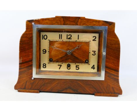 A walnut veneered Art Deco mantel clock with key and pendulum. [W]