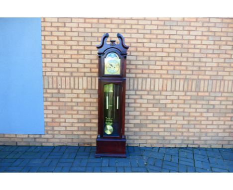 A contemporary long case clock, the brass dial with Roman numerals, with pendulum and weights, instruction manual included