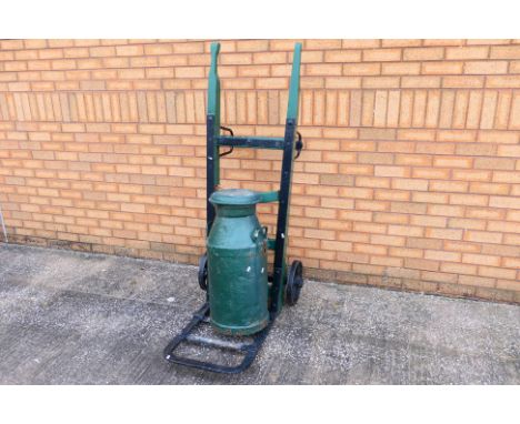 A wood and iron porters trolley, painted green and black with metal plate marked M53746, 157 cm (h) and a green painted milk 