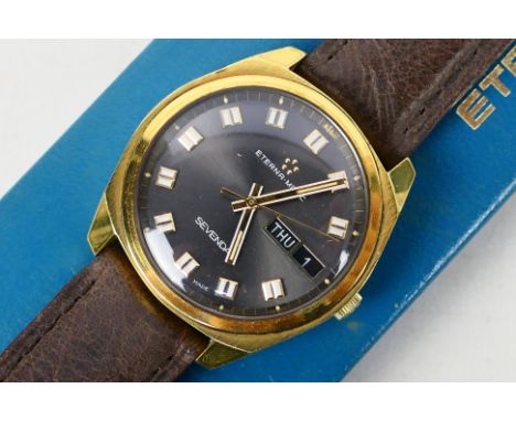 A vintage Eterna Matic wrist watch, gold plated case with day / date at 3 o'clock, on brown leather strap, contained in origi