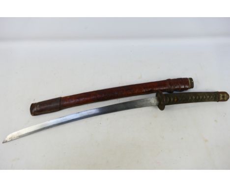 A 20th century short sword, Wakizashi, with 53 cm single edge blade, iron tsuba and leather bound saya, approximately 77 cm (