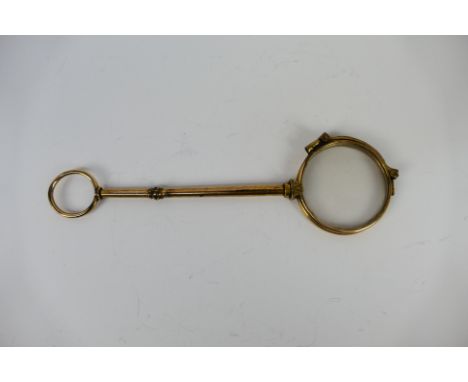 An early 20th century gilt metal lorgnette, 15 cm (l). [W]