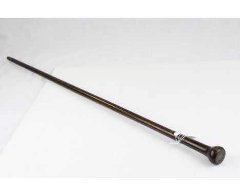 An antique rosewood walking stick with silver coin mounted into the knop