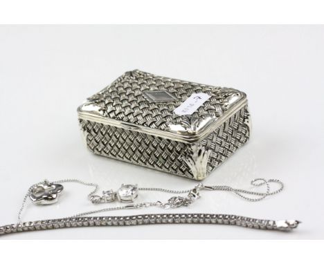 A white metal trinket box with a quantity of jewellery to include a 925 silver tennis bracelet and a Swarovski necklace