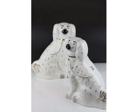 A pair of large ceramic Staffordshire spaniel dogs.