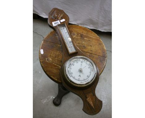 A mid 20th century oak cased banjo style wall barometer.