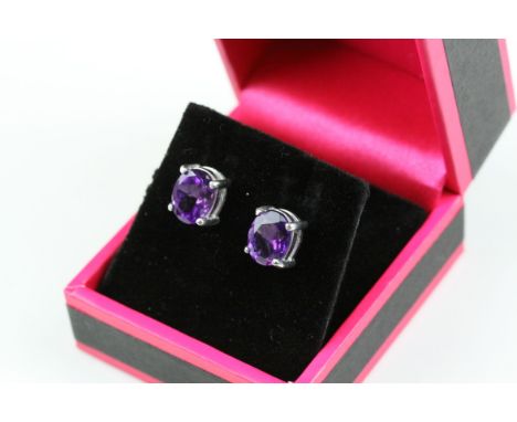 A pair of silver and amethyst stud earrings 