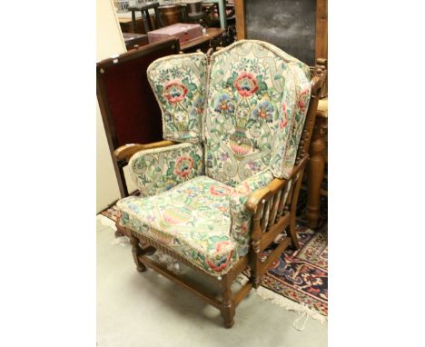 Mid 20th century Ercol Oak Wingback Armchair with brightly floral patterned cushion seats