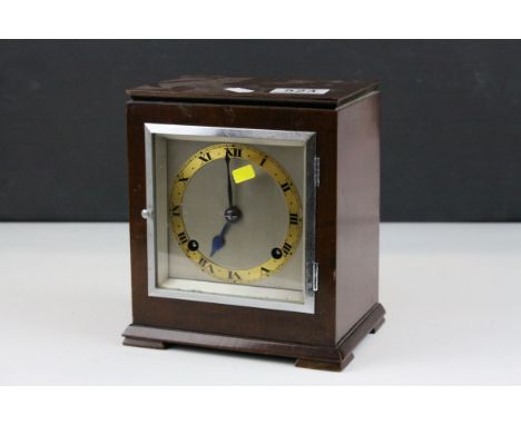 An Art Deco mahogany  two train  mantle clock marked Sorley Glasgow to dial.raised on a plinth base.