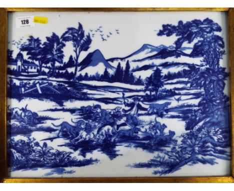 A ceramic tile decorated in blue and white, signed to the reverse, in a gilded frame. Image size 39 cm x 29 cm.