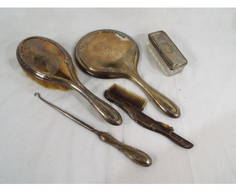 A George V silver hallmarked dressing table set comprising silver backed hand mirror, brush, comb and button hook, Birmingham