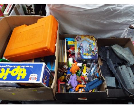 Three boxes of toys to include a fort with a dragon, a quantity of comic book annuals, K-nex, board games and other