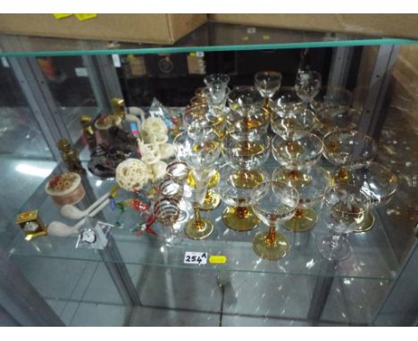 A good mixed lot to include a collection of drinking glasses, hand made glass animals, miniature clocks, clay pipes, a natura