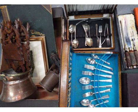 A large mixed lot to include boxed cutlery, books to include the Times Atlas, a print depicting a beach scene, a carving set 