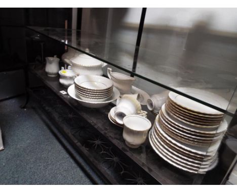 A collection of approximately 48 pieces of ceramic tableware by Chodziez decorated on a white ground with gilded highlights (