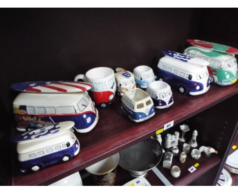 A good collection of eight ceramic VW camper van money boxes, egg cups and candle holders