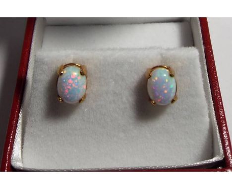 A pair of 9ct gold and opal stud earrings, approx weight 1.3 grams, boxed