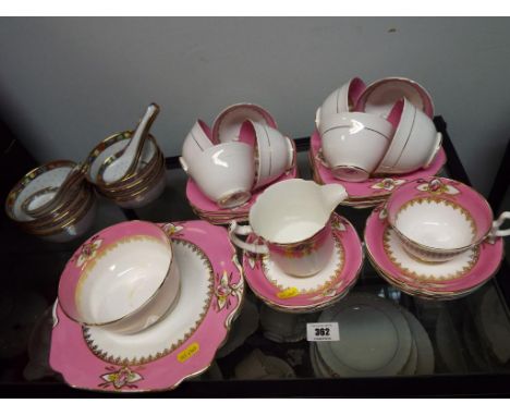 Wellington - a collection of approximately 32 pieces of ceramic tableware by Wellington, in a pink and white and highly gilde