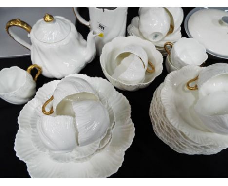 An antique Coalport tea service approximately 30 pieces decorated in white with gilded highlights. Estimate £30 - £50