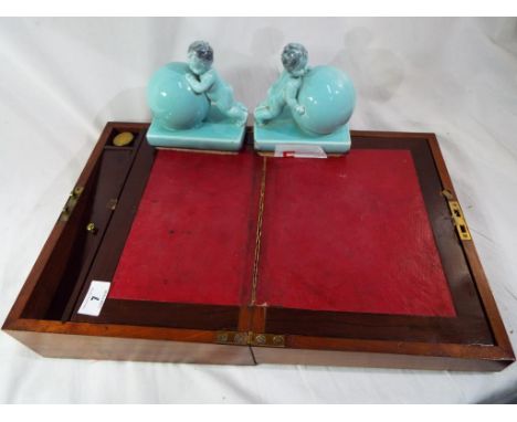 A pair of Art Deco style ceramic book ends in the form of cherubs and a Victorian writing slope. Estimate £20 - £40