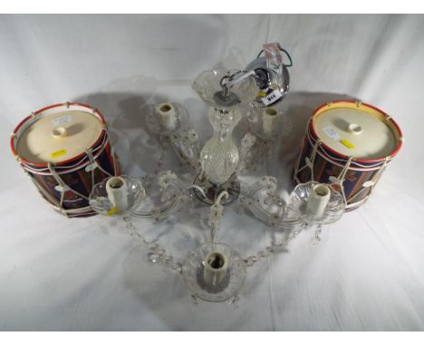 A chandelier light fitting and two ice buckets in the form of drums from the Queens Lancashire regiment