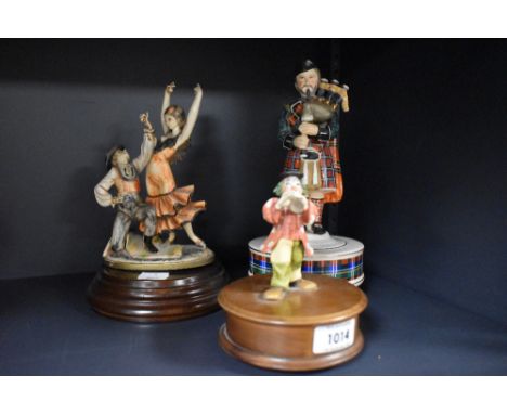 Three vintage musical figurines, including Reuge Swiss made clown with horn.