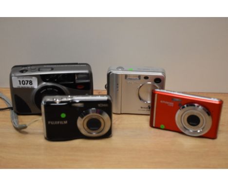 Three digital and one 35mm cameras. A Polaroid IX828, a Fujifilm Finepix F401, a Fujifilm Finepix AV and a Halina Dilhouette 