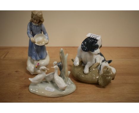 A Royal Doulton figurine, Country Girl and two Nao studies of puppies and geese.