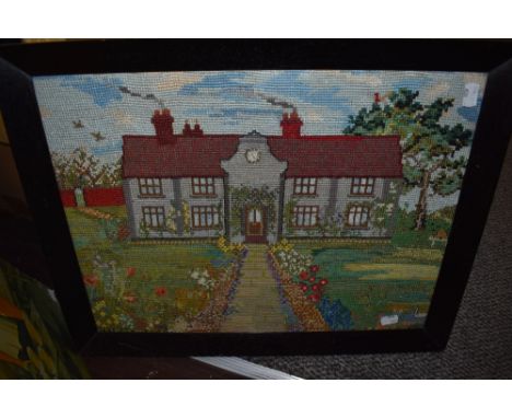 A vintage tapestry depicting country house with garden, framed and glazed.