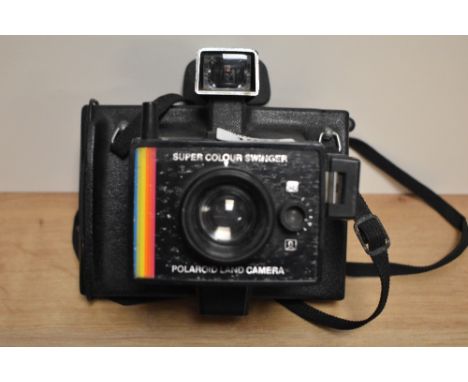 Two cameras. A Polaroid Colour Swinger instant camera and a Hanimex 35AFX camera