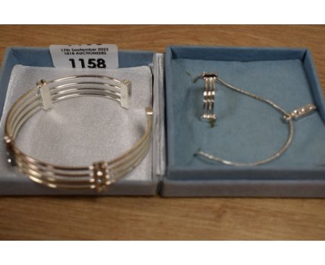 A silver coloured jewellery set, to comprise a matching ring and bangle