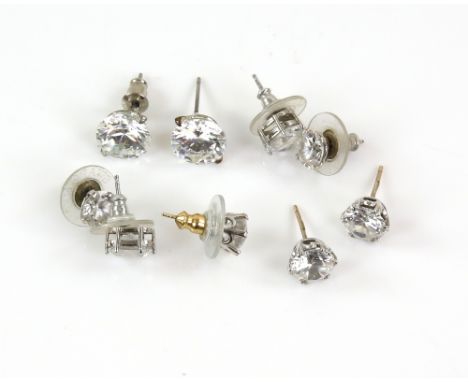 A group of stud earrings set with white synthetic stones, three mounted in 9 ct, one pair mounted in silver and the rest in w