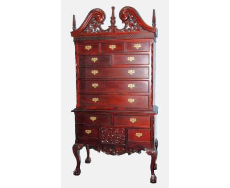 GEORGIAN STYLE MODERN REPRODUCTION CARVED MAHOGANY CHEST ON STAND, the ornate swan neck pediment with central finial and pier