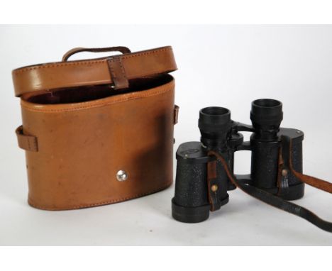 A PAIR OF LEATHER CASED BINOCULARS, a moulded composition rectangular PLAQUE after Leonardo's last Supper, a small oak shield