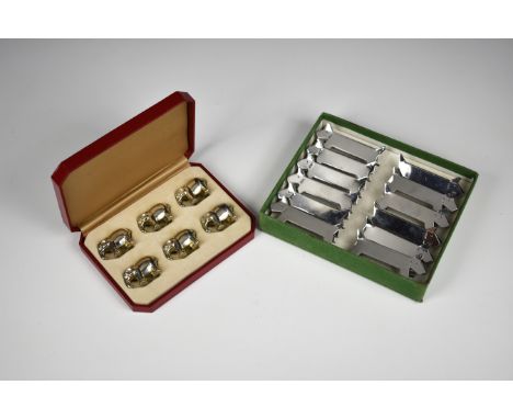 A novelty cased set of vintage knife rests French, the twelve base metal knife rests formed as dogs, together with a cased se