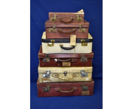 A collection of various vintage suitcases, some with original travel stickers (6)
