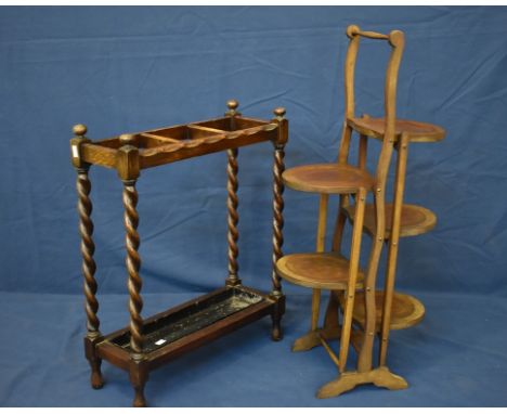 A 1920s carved oak stick / umbrella stand, together with an Edwardian folding mahogany five tier cake stand. (2) 