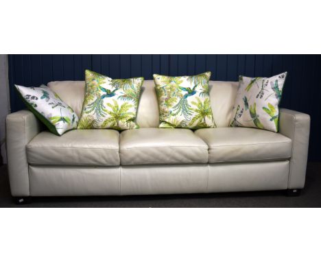 A modern cream leather three seater sofa