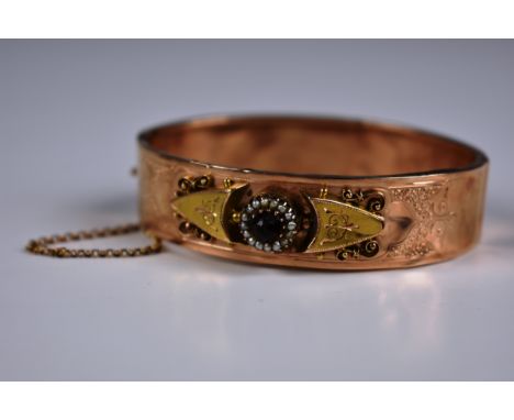 A Victorian 9ct rose gold, seed pearl & red stone bangle 