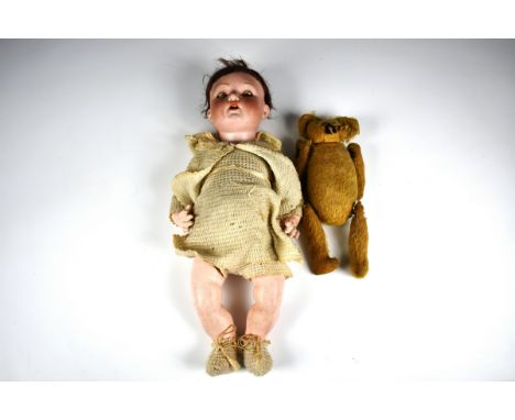 A German bisque head baby dollc.1920, by Welsch & Co., mould no. 150, impressed '150 Welsch Made in Germany 6', with blue gla