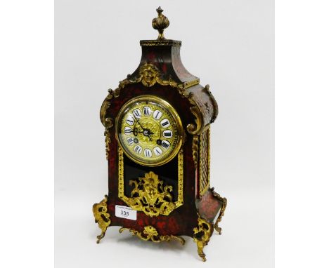 Boule and ormolu mounted mantle clock with brass dial and porcelain Roman numerals with a flume finial top, complete with pen