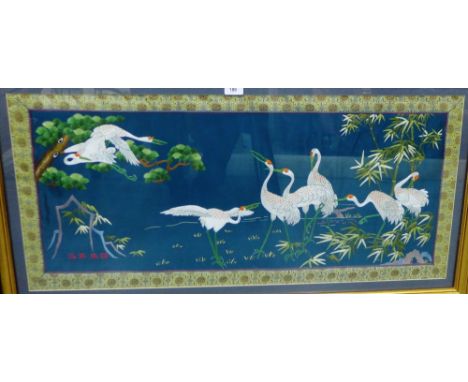 Embroidered panel of cranes, in a glazed and gilt wood frame, 100 x 45cm