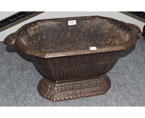 A cast metal twin handled Victorian style planter and a Victorian cast iron paraffin heater (2)