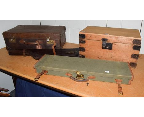 A Brady canvas and leather shotgun case, a leather leg of mutton gun case, an early 20th century leather suitcase, and a meta