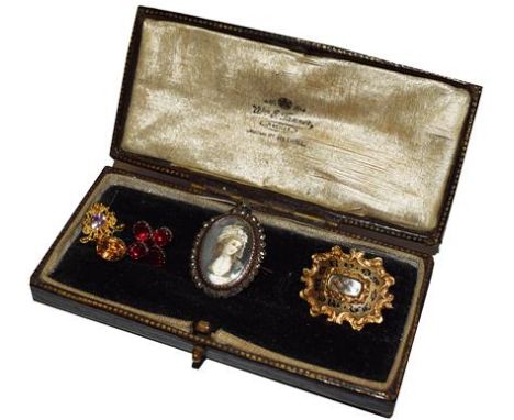 A hairwork mourning brooch, a marcasite portrait miniature brooch and three pendants 