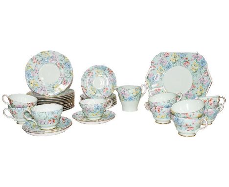 A Shelley Melody pattern tea service, comprising ten trios, a cream jug and a pair of cake plates (one tray)