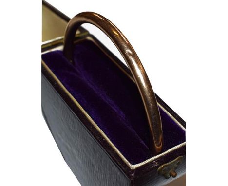A 9 carat gold bangle, inner diameter 7.0cm (cased).  Gross weight 9.1 grams. 